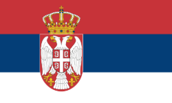 Flag of Serbia with its national coat of arms in the center.
